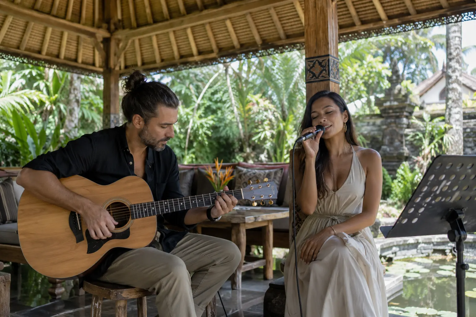 Acoustic guitarist and vocalist rehearsing in a shaded garden pavilion