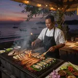 Indonesian chef grilling fresh seafood at a Jimbaran villa with Jimbaran Bay in the background