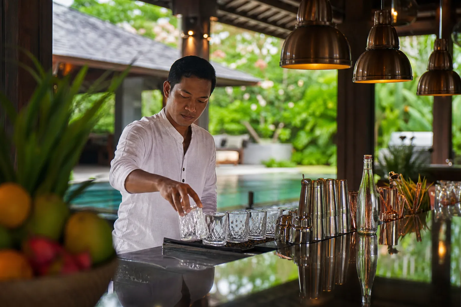 Hotel bartender setting a professional bar station before evening service