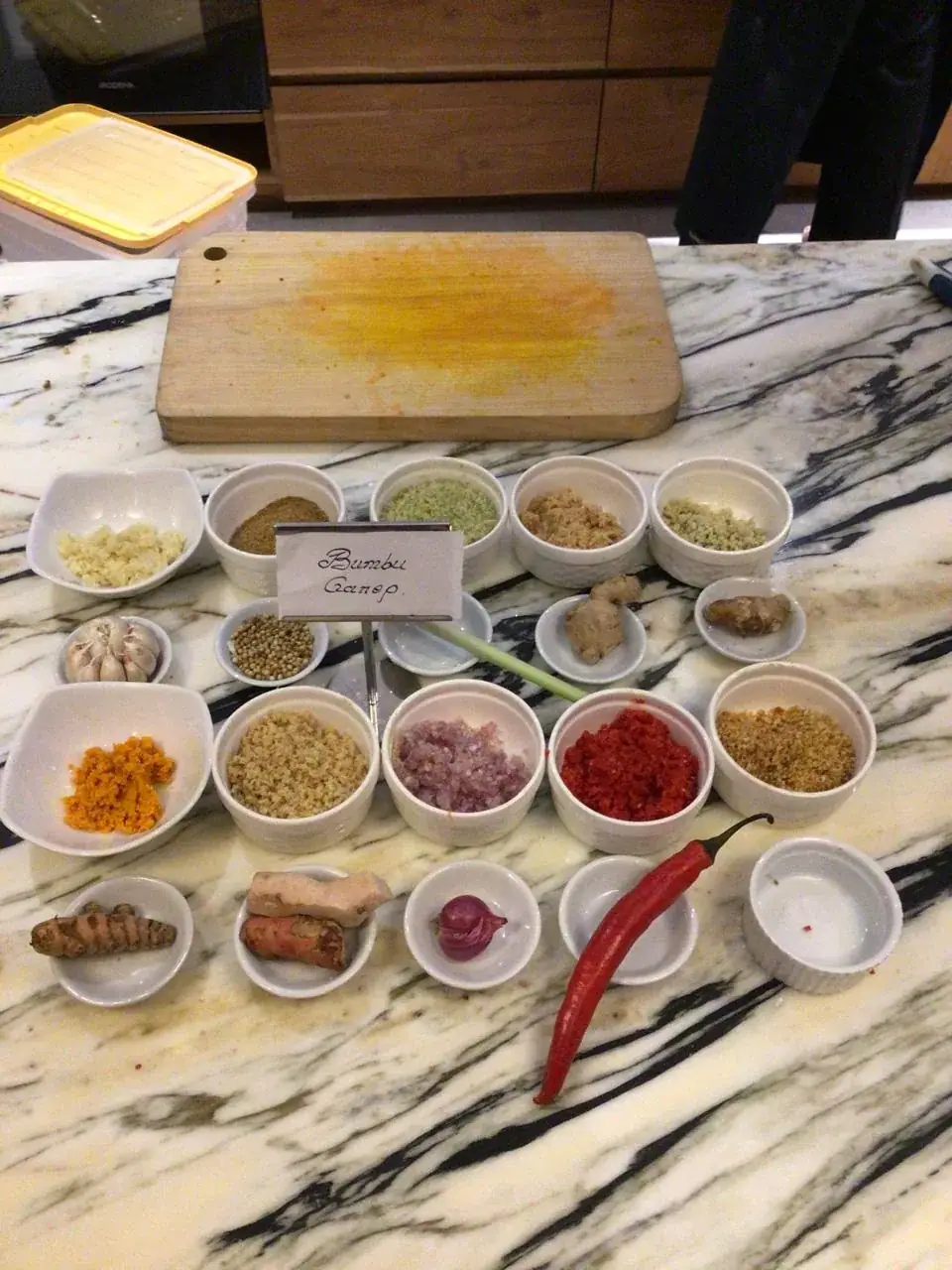 Bumbu Genep spice paste ingredients in labelled bowls on a villa counter