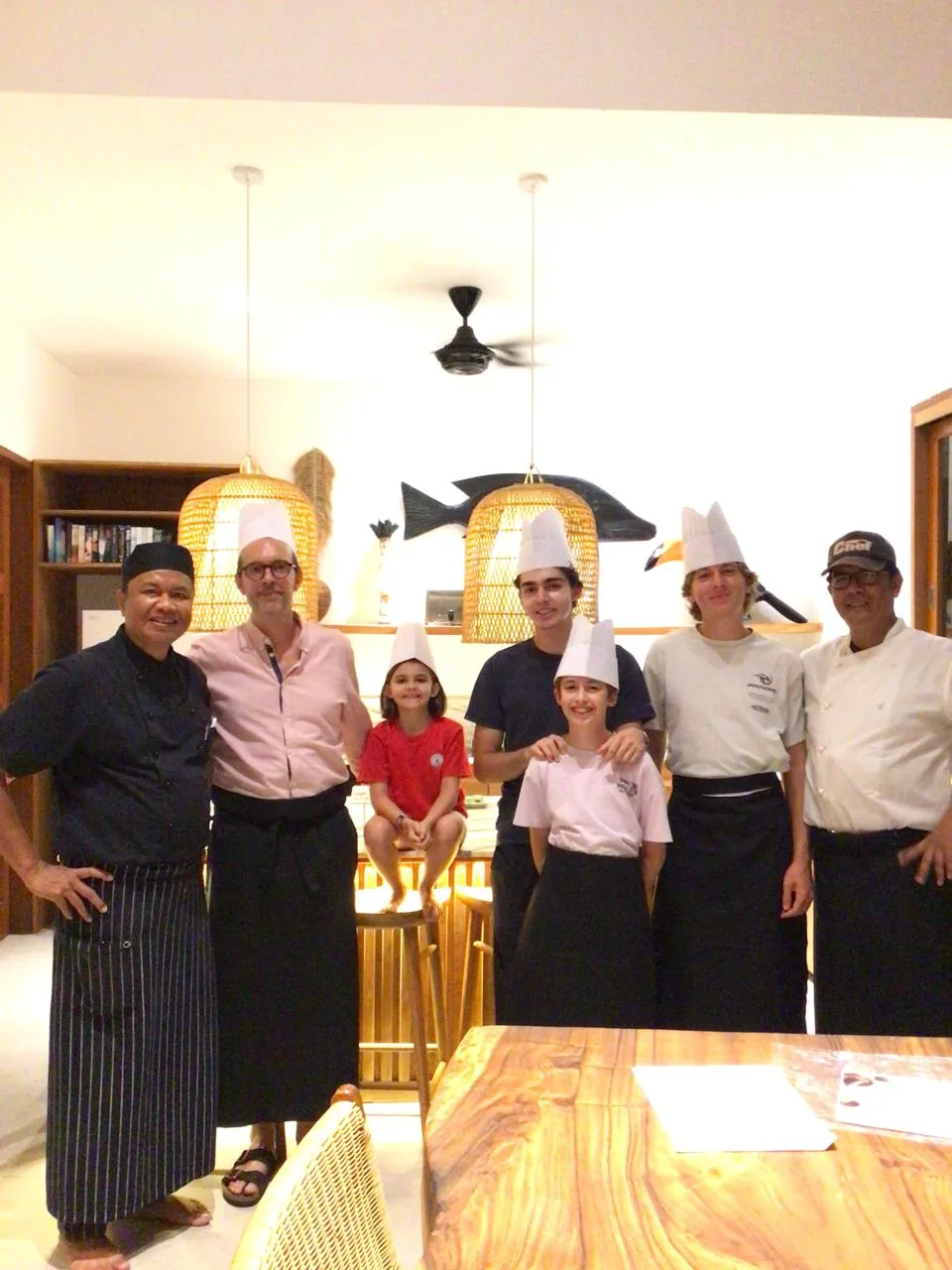 Family and myCHEF chefs in a Bali villa kitchen after a cooking class