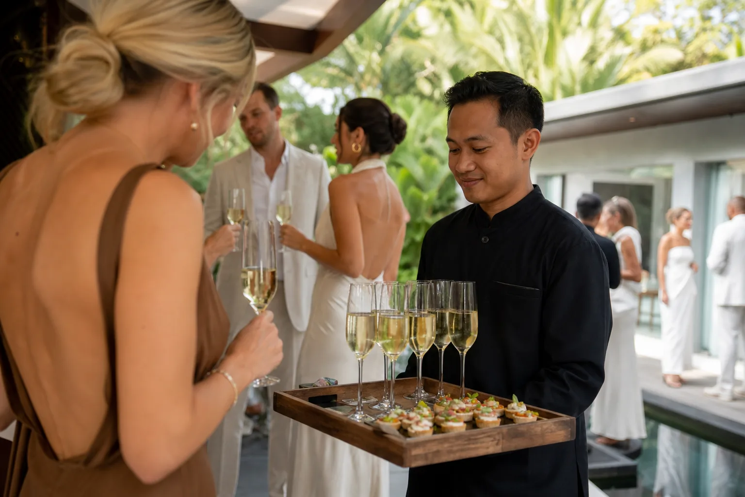 Champagne and canapé service during a Bali villa wedding cocktail hour
