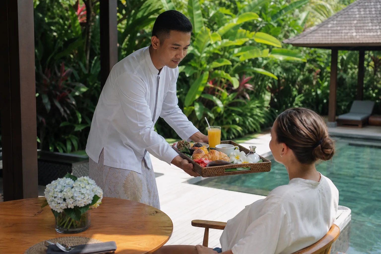 Villa butler in Bali serving breakfast on a private villa terrace