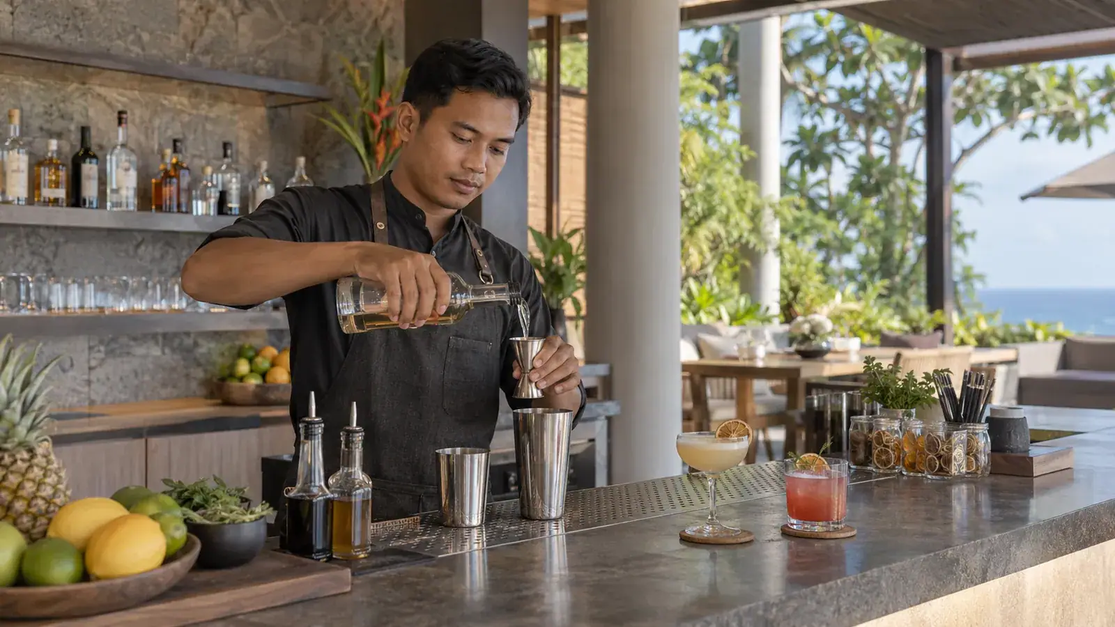 Professional Indonesian bartender preparing a cocktail at a private bar